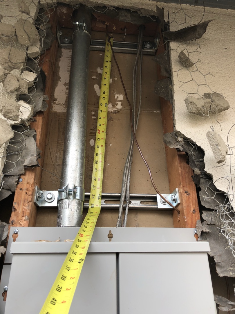 Electrical panel installation with conduit and measurement verification for code-compliant mounting by Burlingame Brothers Electric