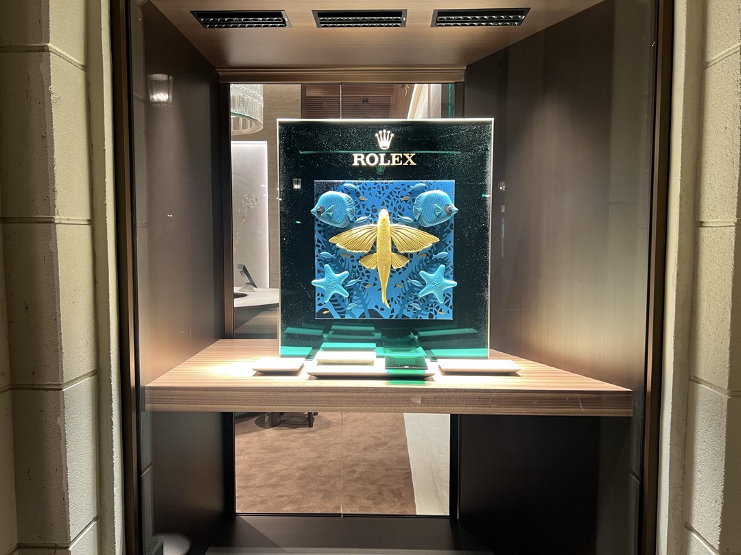 Rolex storefront display window with backlit underwater art installation and custom LED lighting by BBE Electric