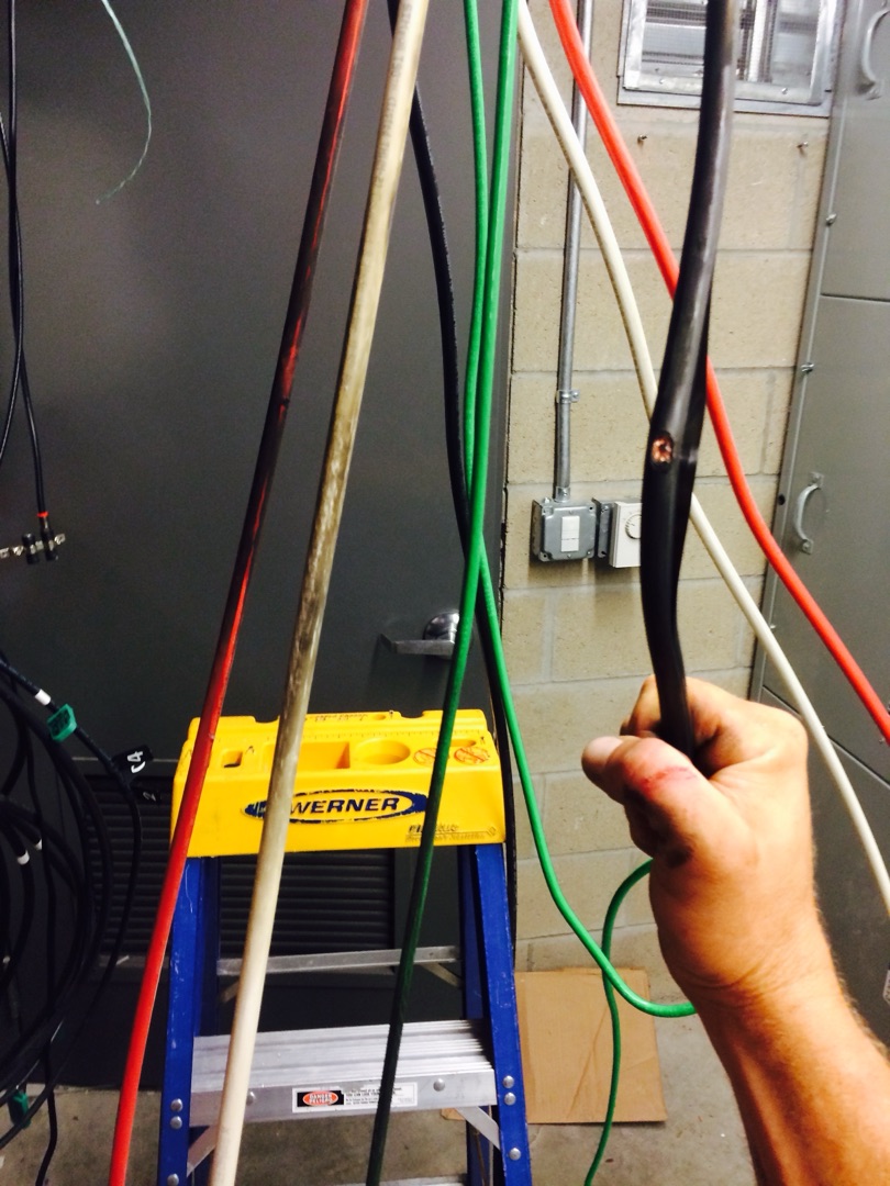 Electrician pulling large-gauge color-coded copper conductors for commercial service installation — Burlingame Brothers Electric